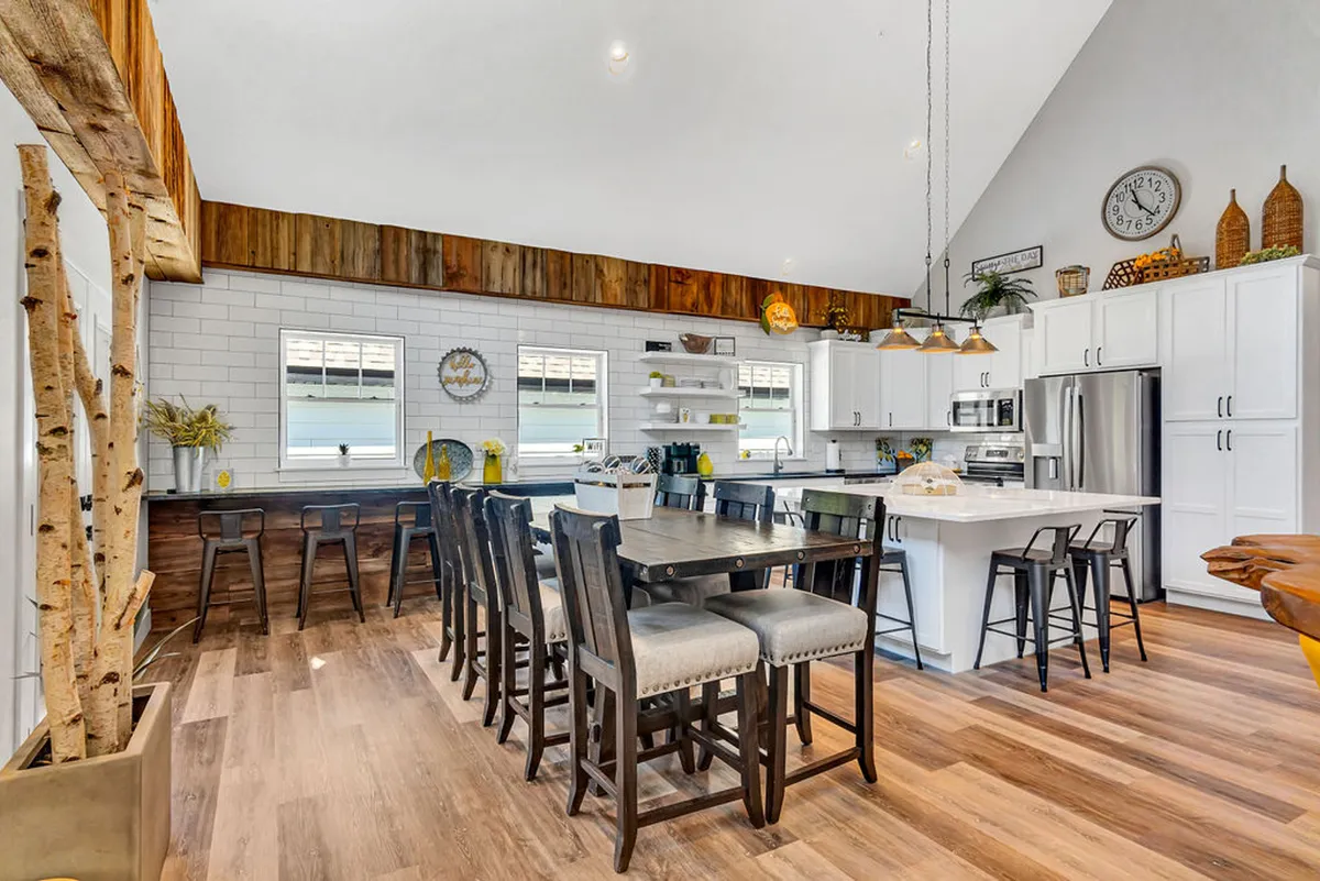 A large open kitchen and dining layout with a substantial dining table, wooden accents, and ample space for family gatherings or communal meals. The inviting setting encourages togetherness and memorable shared experiences.